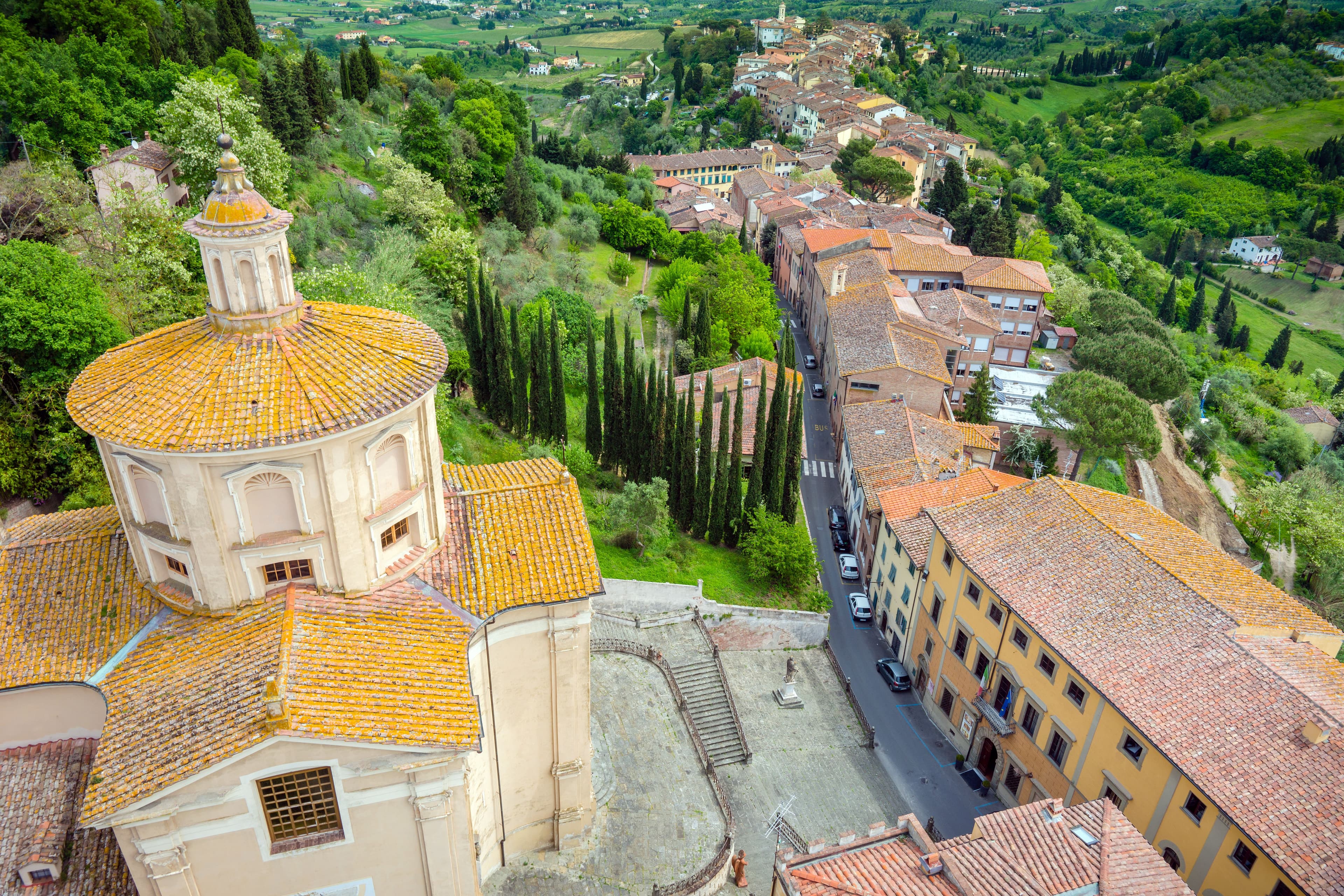 Historic rooftops and green hills in San Miniato