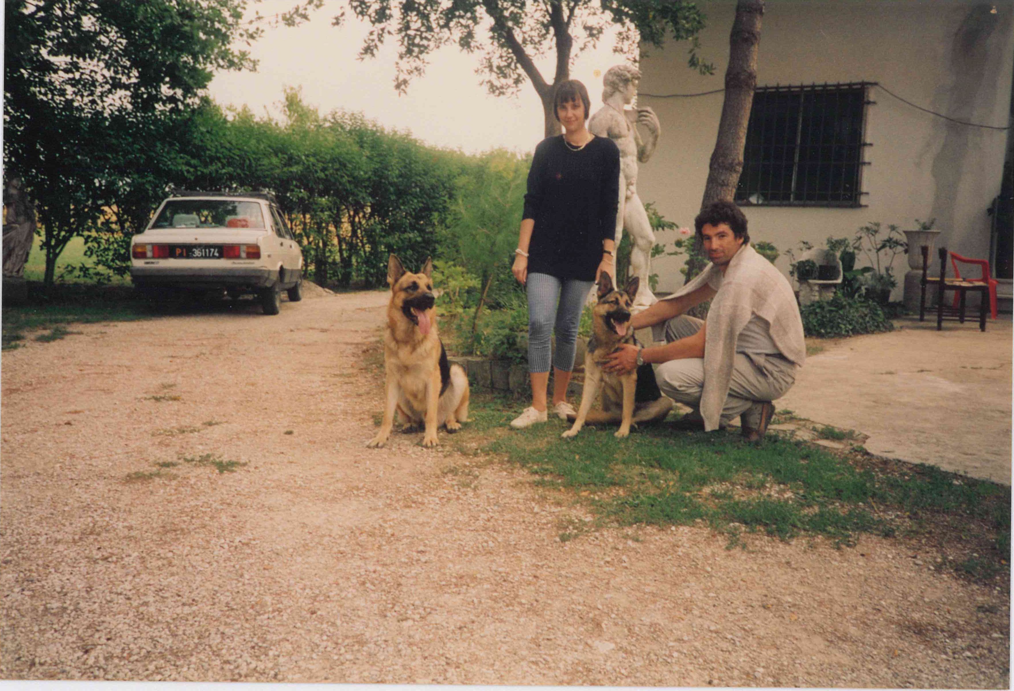 Cristina and Claudio with their two dogs in front of the family house